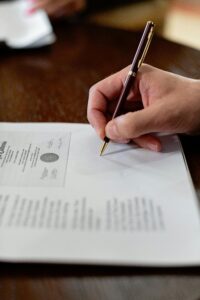  close up of hands filling out insurance forms