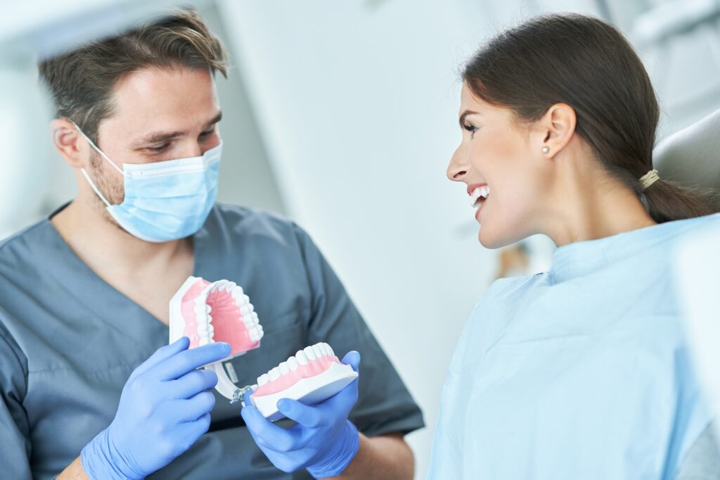 Dentist showing patient full-mouth reconstruction treatment plan in Alexandria, VA