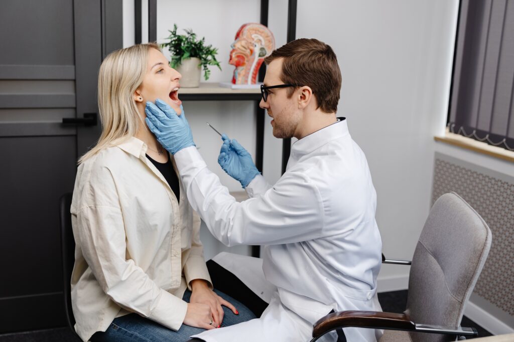 Dentist examining a patient experiencing jaw pain and teeth grinding in Alexandria, VA